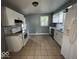 Spacious kitchen with white appliances, tile floors, and modern backsplash at 2507 S Keystone Ave, Indianapolis, IN 46203