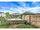 Fenced backyard featuring a concrete patio, well-maintained lawn, and lush trees at 26 E Plum St, Anderson, IN 46012