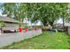 Large backyard featuring a concrete patio, mature trees, and a playground set at 26 E Plum St, Anderson, IN 46012