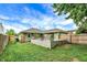 Spacious backyard featuring a concrete block patio and lush lawn at 26 E Plum St, Anderson, IN 46012