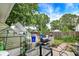 Backyard featuring a concrete patio with greenhouse and barbecue grill at 26 E Plum St, Anderson, IN 46012