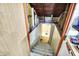 View of the concrete basement stairs leading down, showing unfinished ceiling with wires at 26 E Plum St, Anderson, IN 46012