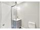 This bathroom features a neo-angle shower with a clear surround and a gray vanity with a white countertop at 26 E Plum St, Anderson, IN 46012
