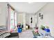 This bedroom features a bed, an arm chair, soft natural light, and built-in shelving at 26 E Plum St, Anderson, IN 46012