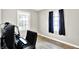 Bright room with computer setup, large windows, and neutral paint at 26 E Plum St, Anderson, IN 46012