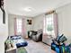 This bedroom features a bed, an arm chair, soft natural light, and built-in shelving at 26 E Plum St, Anderson, IN 46012