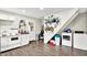 Updated kitchen featuring white appliances and cabinetry, with a view of the laundry setup at 26 E Plum St, Anderson, IN 46012