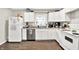 Well-lit kitchen showcasing white cabinetry, stainless steel appliances, and modern countertops at 26 E Plum St, Anderson, IN 46012