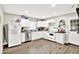 Spacious kitchen featuring white cabinets, stainless steel appliances, and wood-look flooring at 26 E Plum St, Anderson, IN 46012