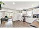 Bright kitchen featuring white cabinets, stainless steel appliances, and modern countertops open to the living room at 26 E Plum St, Anderson, IN 46012