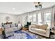Bright living room with cozy couches, natural light and blue rug at 26 E Plum St, Anderson, IN 46012