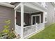Cozy covered back porch with outdoor seating, string lights, and sliding glass doors to the house at 2733 Lamar Dr, Whitestown, IN 46075