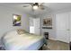Comfortable bedroom with a ceiling fan, warm lighting, and access to an ensuite bathroom at 2733 Lamar Dr, Whitestown, IN 46075