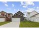 Beautiful home with a long driveway, attached garage, and manicured lawn under a blue sky at 2733 Lamar Dr, Whitestown, IN 46075