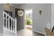 Bright foyer with a decorative wreath on the front door and staircase to the left at 2733 Lamar Dr, Whitestown, IN 46075