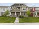 Charming two-story home with stone and siding, featuring a well-manicured lawn and inviting front porch at 2733 Lamar Dr, Whitestown, IN 46075