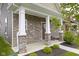 Inviting front porch with stone columns and decorative wreath, creating a welcoming entrance to the home at 2733 Lamar Dr, Whitestown, IN 46075