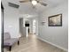 Bright hallway features laminate floors with a view of the stairs, living room, and bathroom at 2733 Lamar Dr, Whitestown, IN 46075