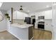 Modern white kitchen with stainless steel appliances, light countertops, and decorative backsplash at 2733 Lamar Dr, Whitestown, IN 46075