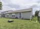 Backyard with grassy lawn, patio, play structures and plenty of space for outdoor activities at 2734 Newaygo Dr, Indianapolis, IN 46217