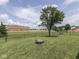Expansive backyard featuring lush green grass, mature tree, and a chain-link fence; idyllic space for outdoor activities and privacy at 2734 Newaygo Dr, Indianapolis, IN 46217