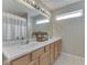 The bathroom features double sinks, a large mirror, and a shower/tub combo at 2734 Newaygo Dr, Indianapolis, IN 46217