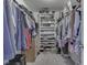 Walk-in closet features built-in shelving and ample storage space for clothes and shoes at 2734 Newaygo Dr, Indianapolis, IN 46217