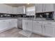 The kitchen features white cabinets, stainless steel appliances, granite countertops and a modern tile backsplash at 2734 Newaygo Dr, Indianapolis, IN 46217