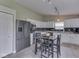 Bright kitchen features stainless steel appliances, white cabinets, granite countertops, and a center island with seating at 2734 Newaygo Dr, Indianapolis, IN 46217