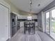 Modern kitchen with white cabinets, black appliances, and stylish table with seating for four at 2734 Newaygo Dr, Indianapolis, IN 46217