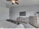 The primary bedroom is finished with a ceiling fan, carpet flooring, and contemporary furniture at 2734 Newaygo Dr, Indianapolis, IN 46217