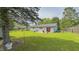A spacious backyard features a patio with red chairs, perfect for enjoying the outdoors at 3019 E Berwyn St, Indianapolis, IN 46203
