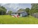 View of the backyard of the home, with a concrete patio and chairs, as well as a fenced in yard at 3019 E Berwyn St, Indianapolis, IN 46203