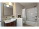 Bathroom featuring an oval mirror, single sink vanity with marble counter, and bath and shower combo at 3019 E Berwyn St, Indianapolis, IN 46203