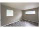 Bedroom featuring gray floors, two windows, and neutral paint at 3019 E Berwyn St, Indianapolis, IN 46203