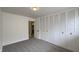 Bedroom featuring gray carpet, a closet with bi-fold doors, and neutral paint at 3019 E Berwyn St, Indianapolis, IN 46203