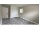 Bedroom featuring gray floors, a window, and a closet with bi-fold doors at 3019 E Berwyn St, Indianapolis, IN 46203