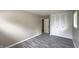 Bedroom featuring gray floors, a window, and a closet with bi-fold doors at 3019 E Berwyn St, Indianapolis, IN 46203