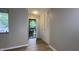 Bright entryway with wood-look flooring, coat closet, and decorative security door at 3019 E Berwyn St, Indianapolis, IN 46203