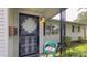 Close-up of the front door featuring decorative security door, light fixture, and seating at 3019 E Berwyn St, Indianapolis, IN 46203
