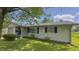 A cozy home featuring dark shutters, a small front porch, and healthy green shrubs at 3019 E Berwyn St, Indianapolis, IN 46203