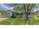 Charming home with a well-maintained front yard, mature tree, and attached garage at 3019 E Berwyn St, Indianapolis, IN 46203
