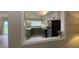 The kitchen is viewed through a wall cut-out, showcasing the stainless appliances and butcher-block countertops at 3019 E Berwyn St, Indianapolis, IN 46203