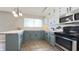 Modern kitchen with stainless steel appliances, butcher block counters, and updated lighting at 3019 E Berwyn St, Indianapolis, IN 46203