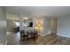 Living and dining area with wood-look flooring, an open floor plan, and neutral paint at 3019 E Berwyn St, Indianapolis, IN 46203