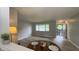 Bright living room with updated flooring, large windows, and a front door entry at 3019 E Berwyn St, Indianapolis, IN 46203