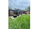 Cozy backyard featuring a covered patio, lush green lawn, and well-manicured landscaping at 3130 Taylor Rd, Columbus, IN 47203