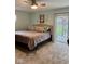 Bright bedroom with a ceiling fan and view of backyard patio at 3130 Taylor Rd, Columbus, IN 47203