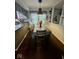 Eat-in kitchen with dining table, pendant lighting, and view of backyard at 3130 Taylor Rd, Columbus, IN 47203
