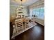 Dining room with hardwood floors, a decorative light fixture and large window at 3130 Taylor Rd, Columbus, IN 47203